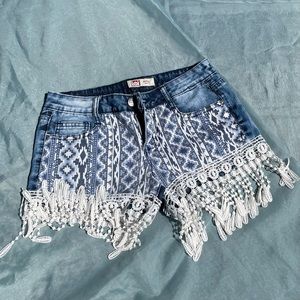 Blue shorts, with white tassels and tribal print. Worn Once Size: Small